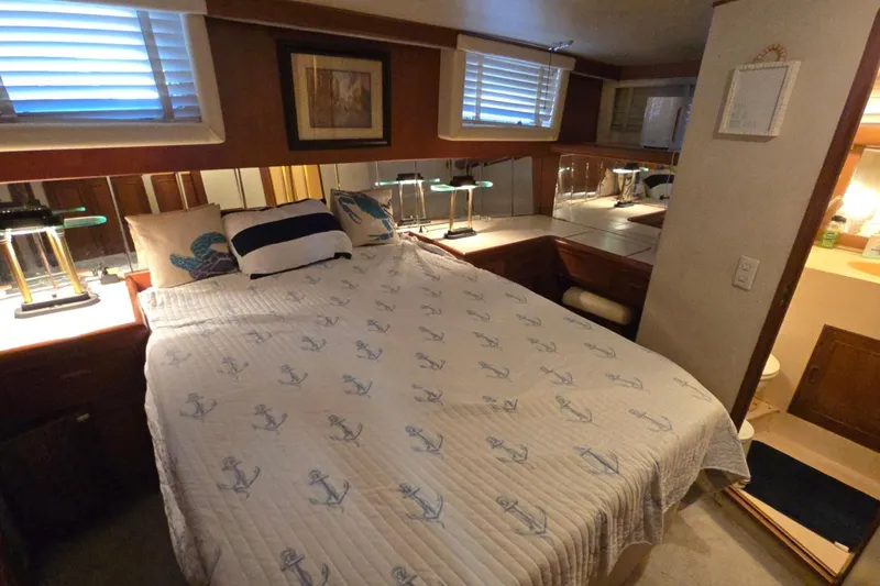 Slide: The Image of Cozy bedroom in 1990 Pace 42 yacht with nautical-themed bedding and ambient lighting. - 58