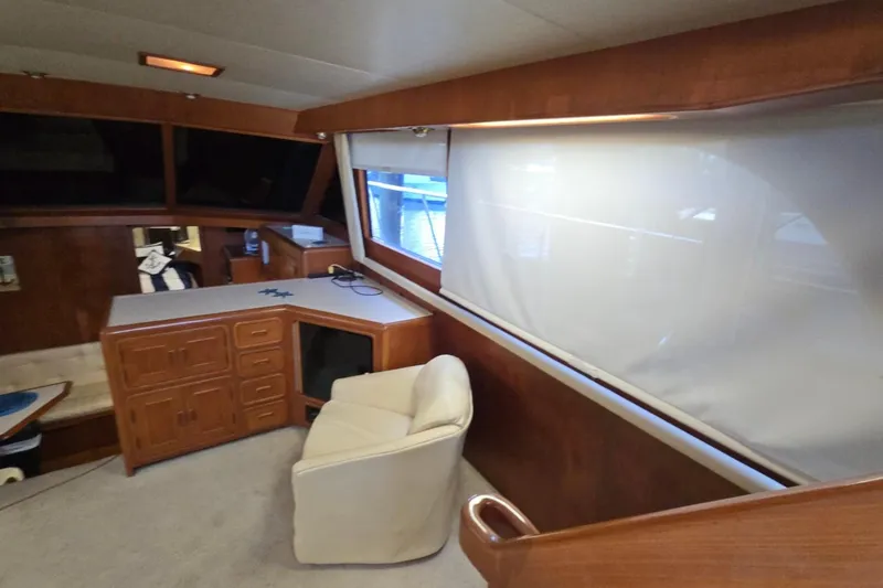 Slide: The Image of Interior of 1990 Pace 42 yacht with wooden cabinetry and a white chair. - 16