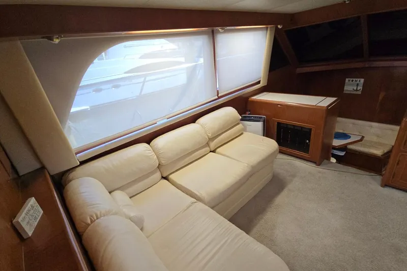 Slide: The Image of Luxurious interior of a 1990 Pace 42 yacht with cream sofa and wooden cabinetry. - 18