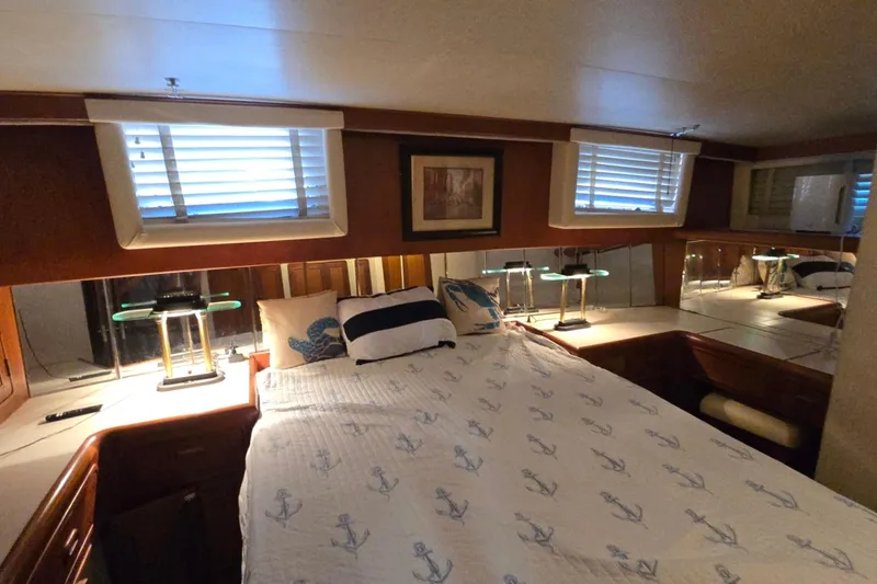 Slide: The Image of Cozy bedroom in 1990 Pace 42 yacht with nautical-themed bedding and ambient lighting. - 54