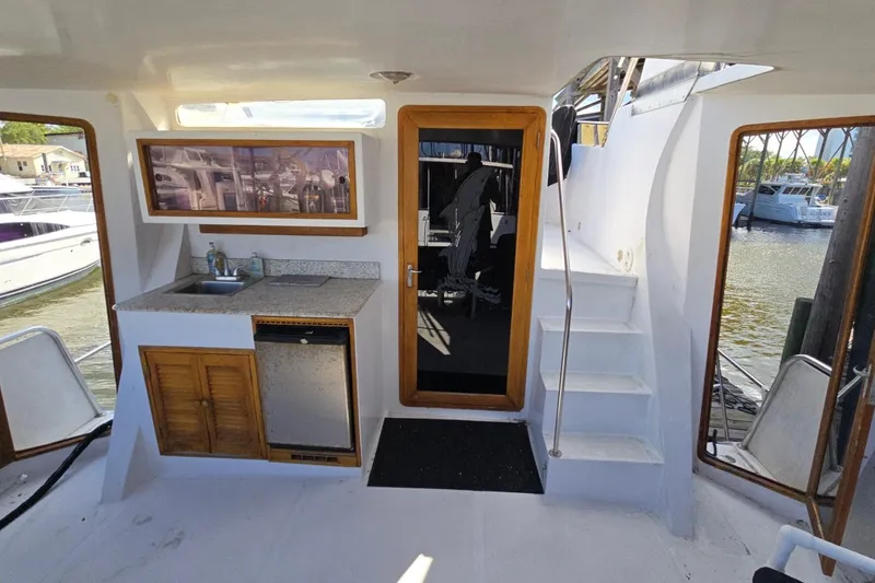 Slide: The Image of Interior view of 1990 Pace 42 yacht with kitchenette and stairs. - 5