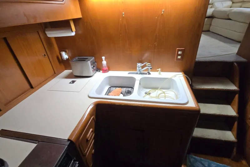 Slide: The Image of Compact kitchen area in a 1990 Pace 42 boat with sink and toaster. - 31