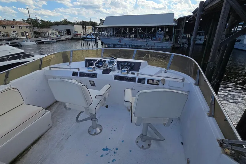 Slide: The Image of Cockpit of a 1990 Pace 42 boat with dual seats and marina view. - 10