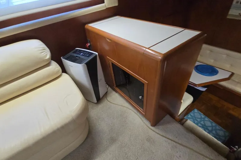 Slide: The Image of Interior of a 1990 Pace 42 yacht with beige seating and wooden cabinetry. - 24