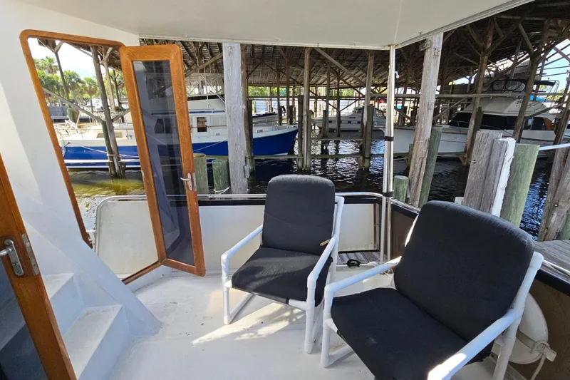 Slide: The Image of Two chairs on the deck of a 1990 Pace 42 boat, docked in a marina. - 4