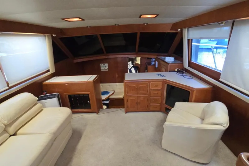 Slide: The Image of Luxurious 1990 Pace 42 yacht interior with plush seating and wooden cabinetry. - 17