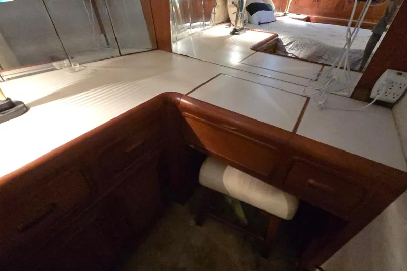 Slide: The Image of Interior of a 1990 Pace 42 yacht with wooden cabinetry and mirrored surfaces. - 59