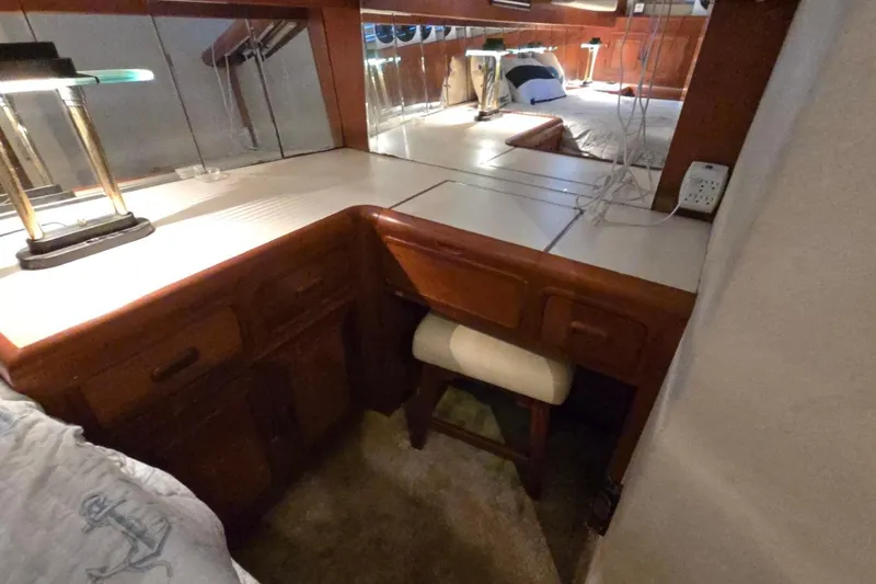 Slide: The Image of Cozy 1990 Pace 42 yacht interior with wooden desk, mirror, and lamp. - 56