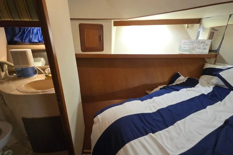 Slide: The Image of Cozy cabin interior of a 1990 Pace 42 boat with bed and compact bathroom. - 47