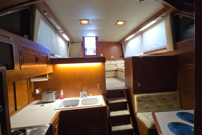Slide: The Image of Interior of a 1990 Pace 42 yacht featuring a cozy kitchen and seating area. - 33