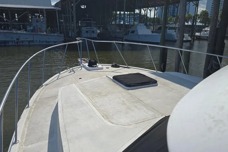 Slide: The Image of Bow view of a 1990 Pace 42 yacht docked at a marina. - 8
