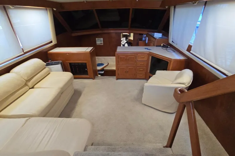 Slide: The Image of Interior of a 1990 Pace 42 yacht with beige seating and wooden cabinetry. - 51