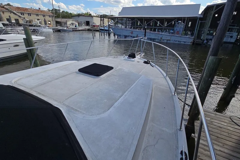 Slide: The Image of Bow view of a 1990 Pace 42 yacht docked at a marina. - 9