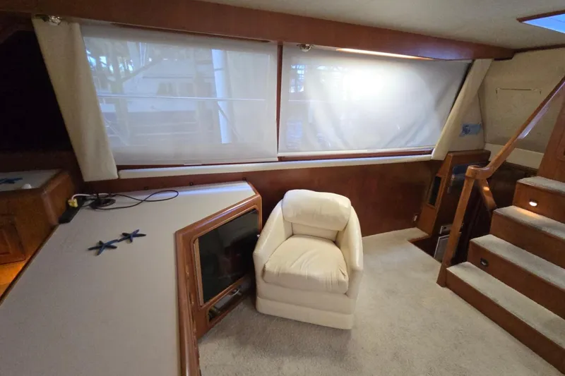 Slide: The Image of Interior of 1990 Pace 42 yacht with white chair and wooden accents. - 20