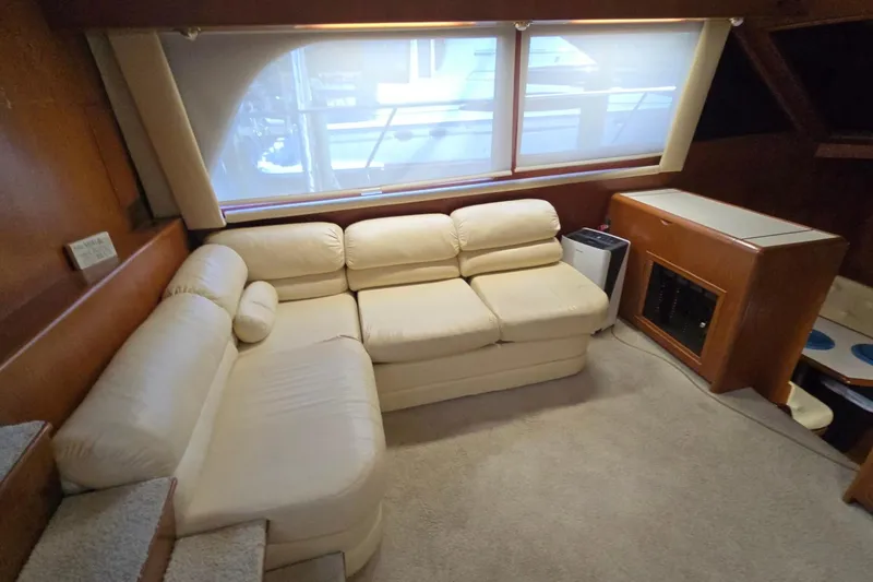 Slide: The Image of Luxurious interior of 1990 Pace 42 yacht with cream sofa and wooden cabinetry. - 22