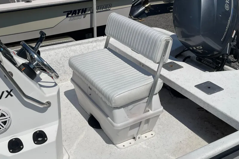 Slide: The Image of Kenner 180 VX 2006 boat interior with white seating and steering wheel. - 11