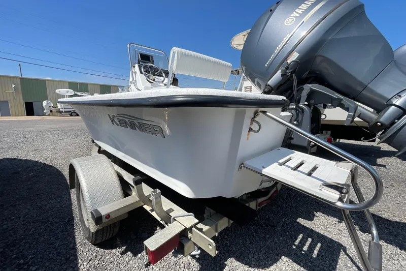 Slide: The Image of 2006 Kenner 180 VX boat on trailer with Yamaha outboard motor, parked outdoors. - 6