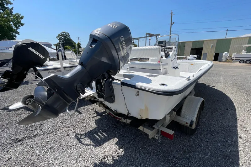 Slide: The Image of 2006 Kenner 180 VX boat with Yamaha outboard motor on trailer in a boatyard. - 7