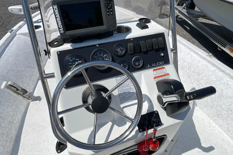 Slide: The Image of Steering console of a 2006 Kenner 180 VX boat with Lowrance GPS and JL Audio system. - 12