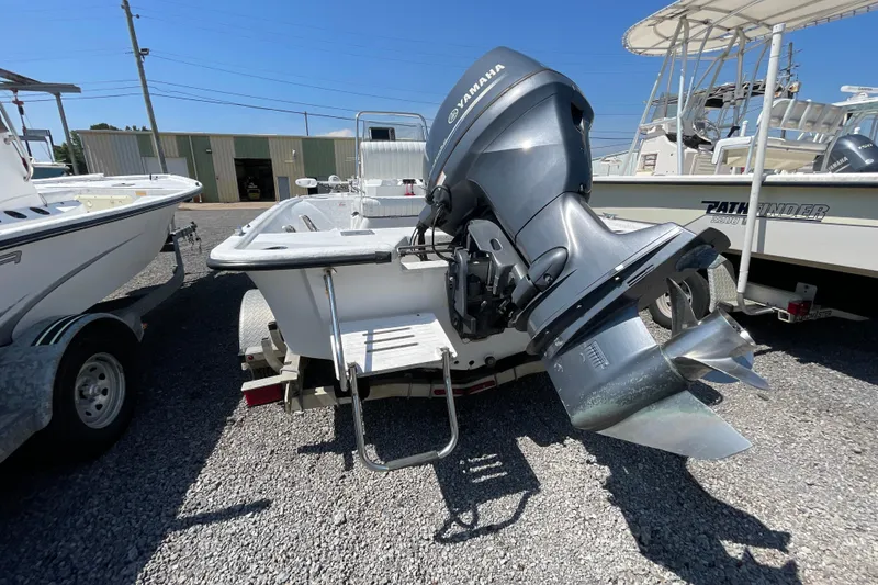 Slide: The Image of 2006 Kenner 180 VX boat with Yamaha outboard motor, parked on gravel lot. - 8