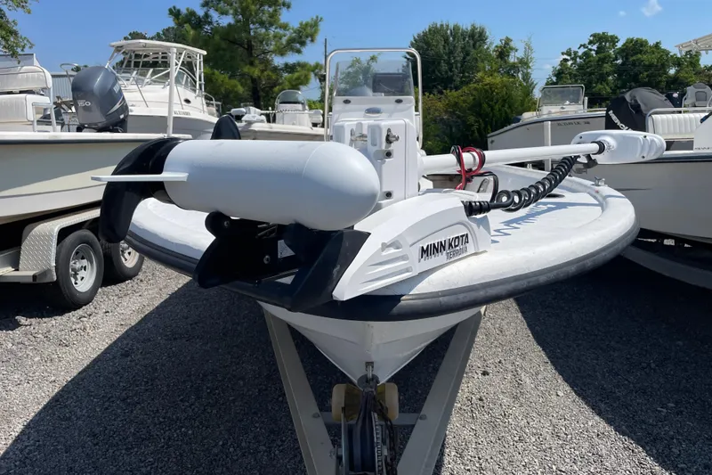 Slide: The Image of 2006 Kenner 180 VX boat with Minn Kota Terrova motor, parked on gravel lot. - 2