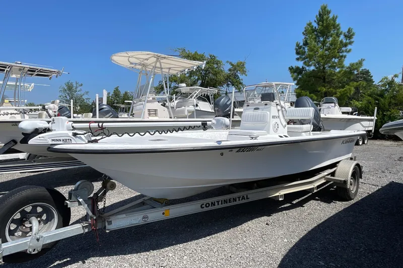 Slide: The Image of 2006 Kenner 180 VX boat on trailer, featuring Minn Kota trolling motor, parked outdoors. - 4