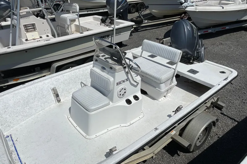 Slide: The Image of 2006 Kenner 180 VX boat with dual seating and steering console, parked on a trailer. - 9