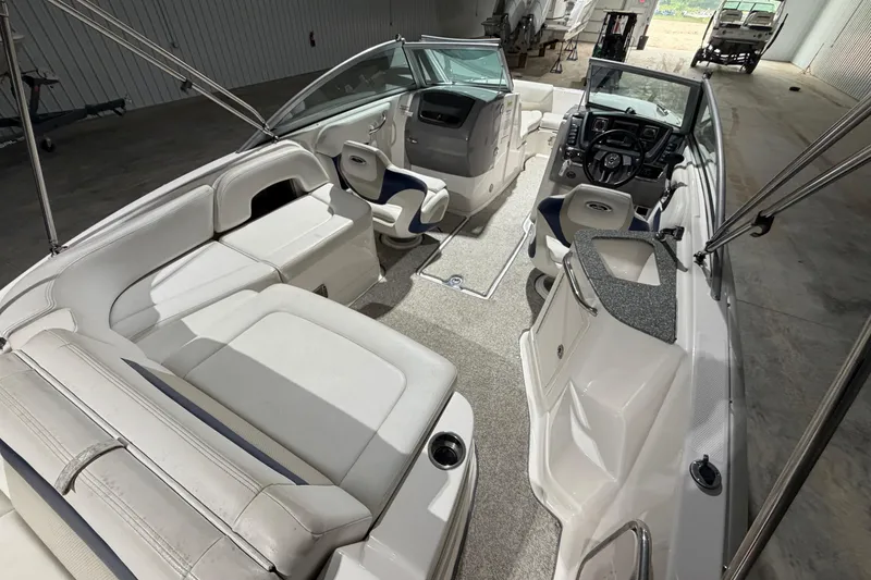 Slide: The Image of Interior view of a 2013 Chaparral 224 Sunesta boat with spacious seating and modern controls. - 10