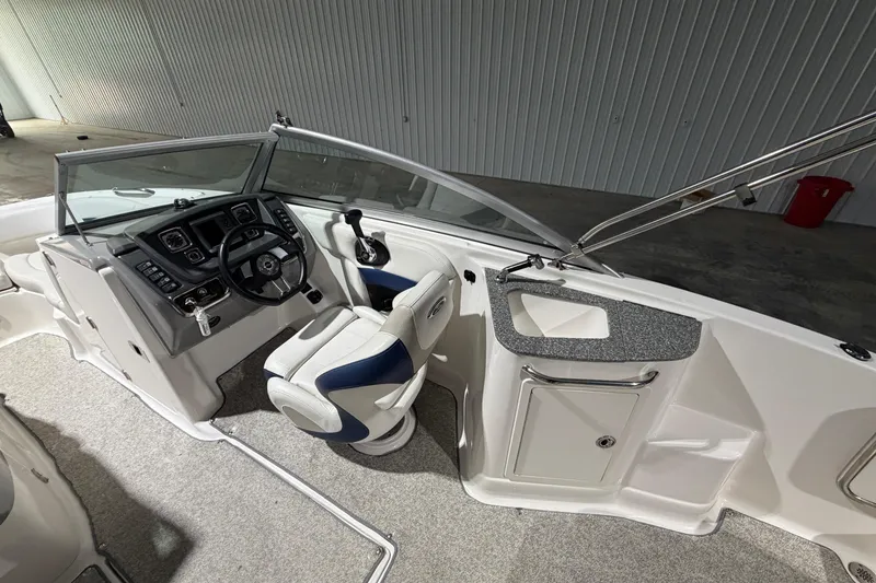 Slide: The Image of 2013 Chaparral 224 Sunesta boat interior with steering wheel and seating. - 9