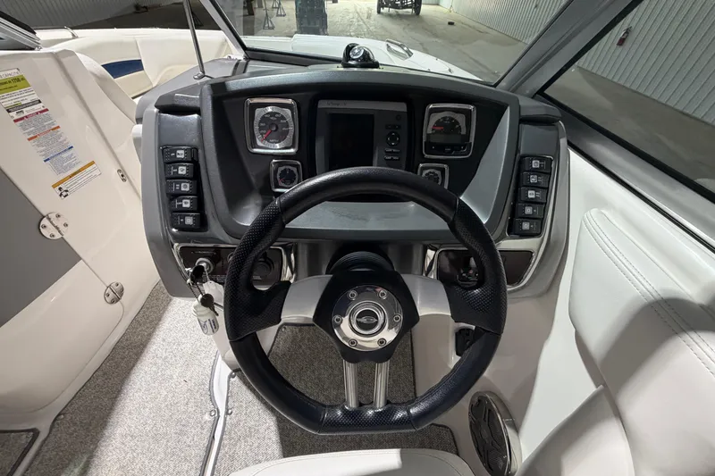 Slide: The Image of Cockpit view of 2013 Chaparral 224 Sunesta boat with steering wheel and dashboard controls. - 6