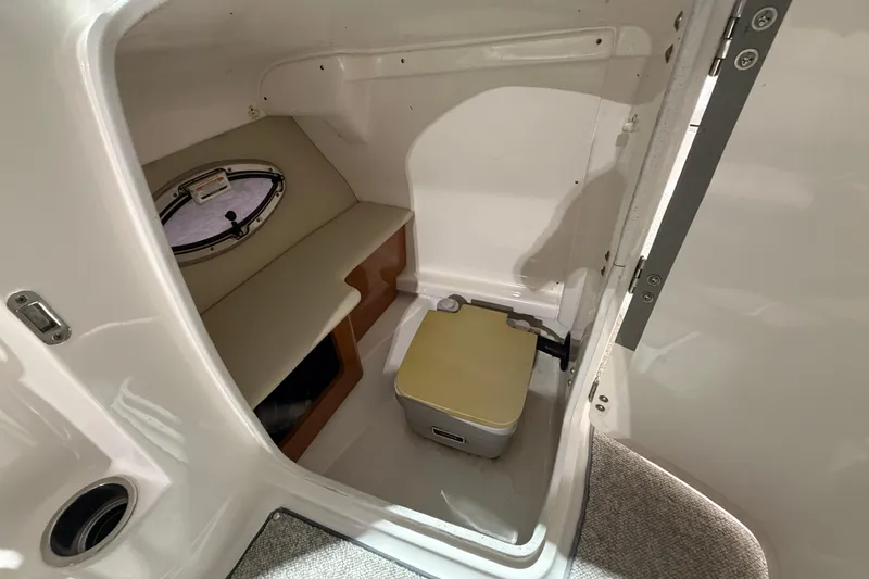 Slide: The Image of Interior cabin of 2013 Chaparral 224 Sunesta boat with seating and portable toilet. - 14