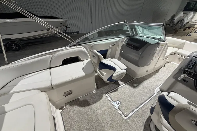 Slide: The Image of 2013 Chaparral 224 Sunesta boat interior with white seating and modern dashboard. - 8