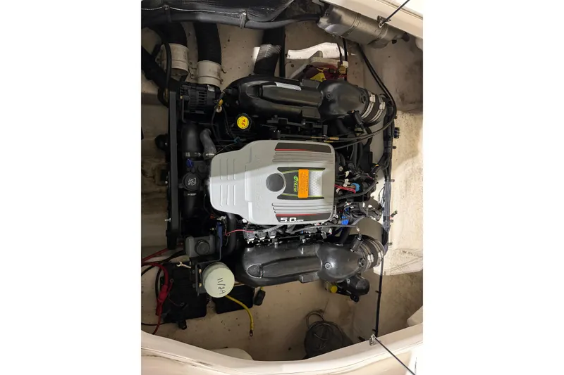 Slide: The Image of Engine compartment of 2013 Chaparral 224 Sunesta boat, showcasing a 5.0L engine. - 15