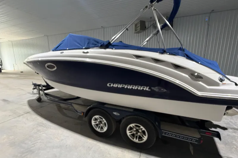 Slide: The Image of 2013 Chaparral 224 Sunesta boat on trailer in indoor storage facility. - 2