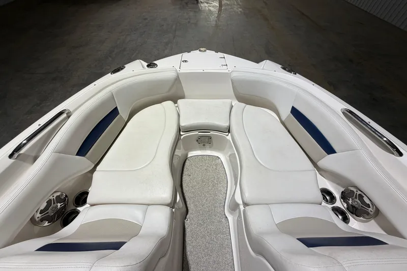 Slide: The Image of 2013 Chaparral 224 Sunesta boat interior with white seating and cup holders. - 12