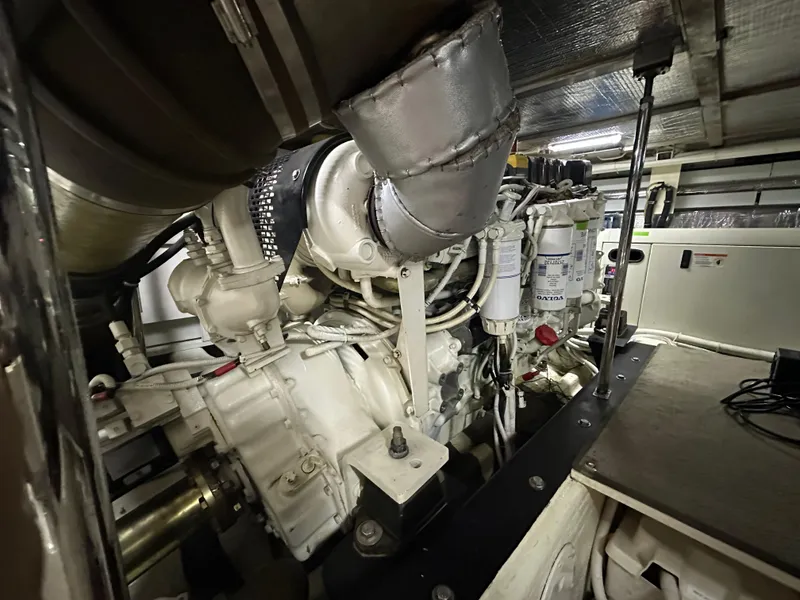 Slide: The Image of Engine room of a 2005 Carver 56 Voyager yacht, showcasing mechanical components. - 48