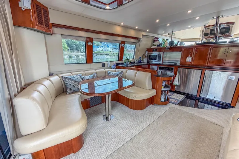 Slide: The Image of Luxurious 2005 Carver 56 Voyager yacht interior with elegant dining area and modern kitchen. - 30