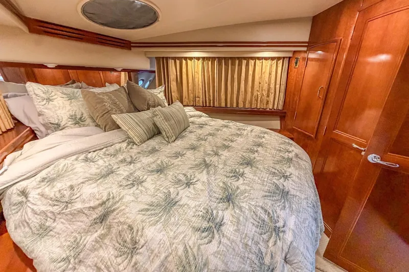 Slide: The Image of Luxurious bedroom interior of 2005 Carver 56 Voyager yacht with elegant bedding. - 14