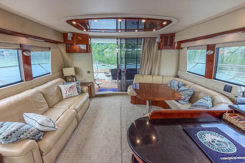 Slide: The Image of Luxurious interior of a 2005 Carver 56 Voyager yacht with elegant seating and lake view. - 34