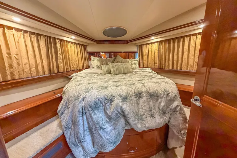 Slide: The Image of Luxurious bedroom interior of 2005 Carver 56 Voyager yacht with elegant bedding. - 13