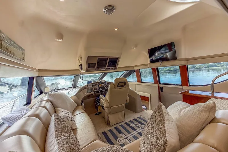 Slide: The Image of Luxurious interior of a 2005 Carver 56 Voyager yacht with plush seating and helm. - 26
