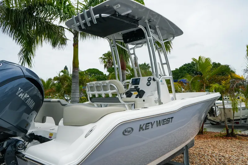 Slide: The Image of 2026 Key West 203 FS boat with Yamaha engine, parked near palm trees. - 4