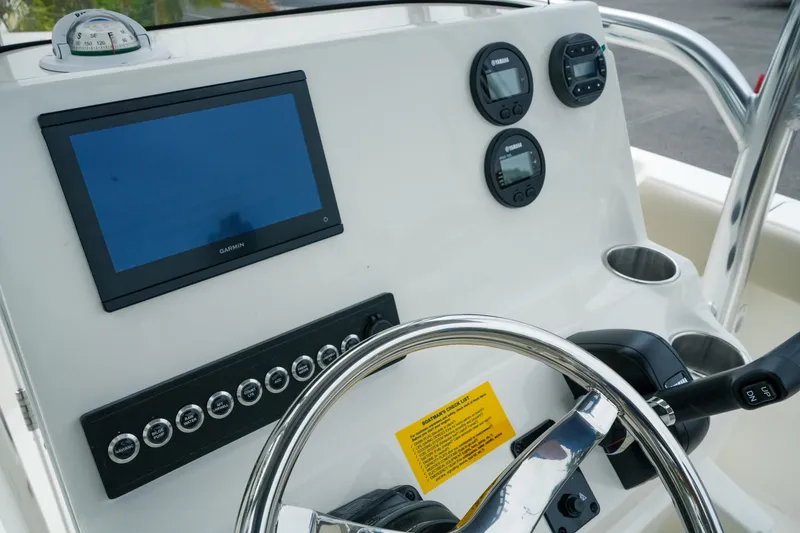 Slide: The Image of 2026 Key West 203 FS boat dashboard with Garmin display and Yamaha controls. - 13