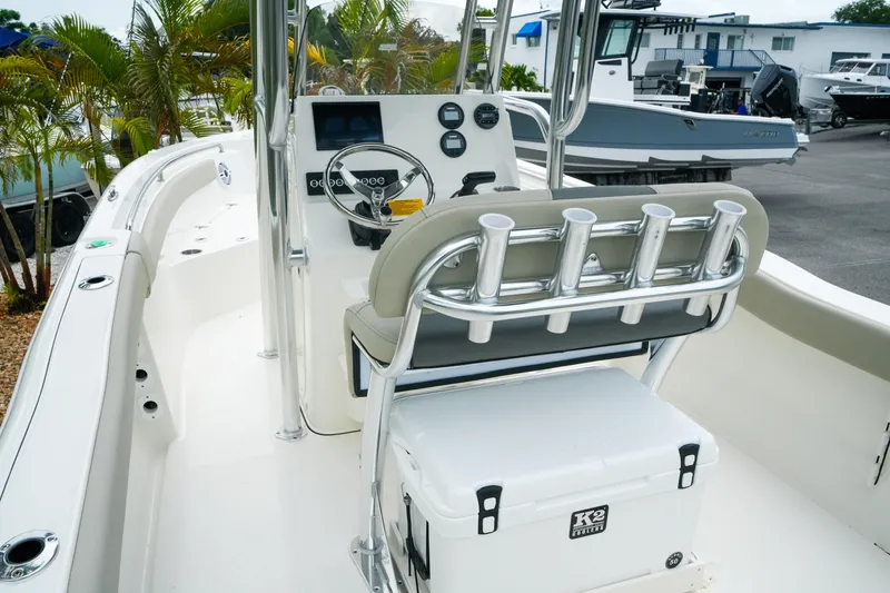 Slide: The Image of 2026 Key West 203 FS boat interior with steering console and rod holders. - 9