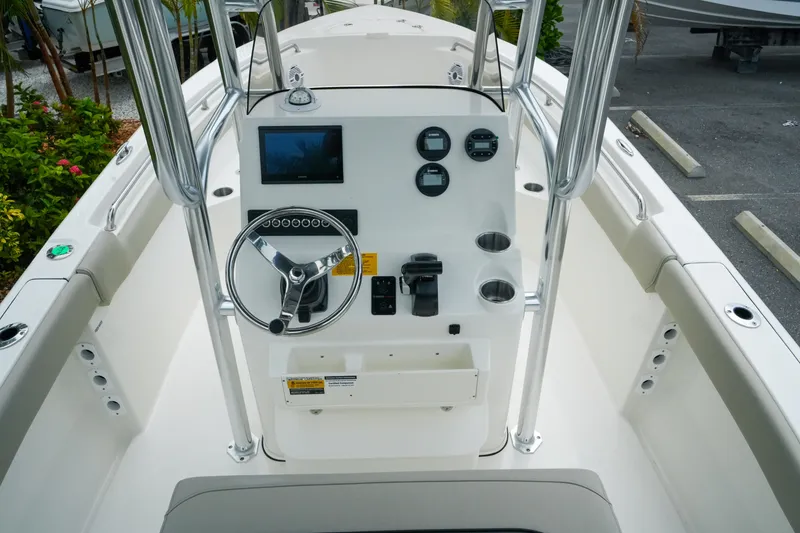 Slide: The Image of 2026 Key West 203 FS boat console with steering wheel, gauges, and navigation screen. - 12