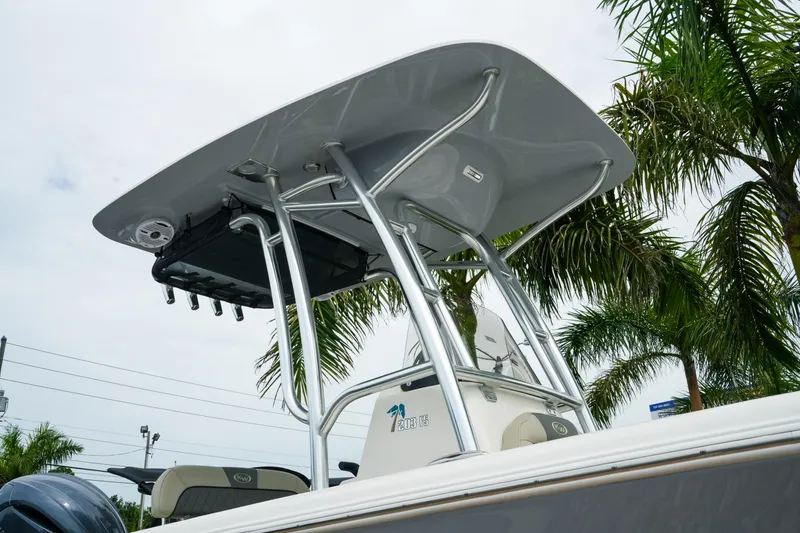 Slide: The Image of 2026 Key West 203 FS boat with T-top, surrounded by palm trees. - 3
