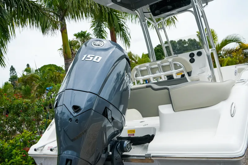 Slide: The Image of 2026 Key West 203 FS boat with Yamaha 150 outboard motor, surrounded by tropical foliage. - 5