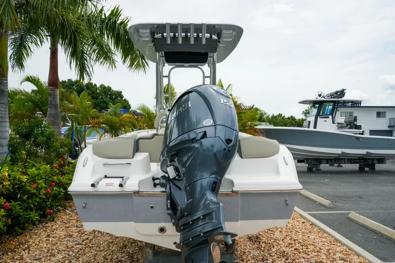 Slide: The Image of 2026 Key West 203 FS boat with Yamaha outboard motor, parked near palm trees. - 6
