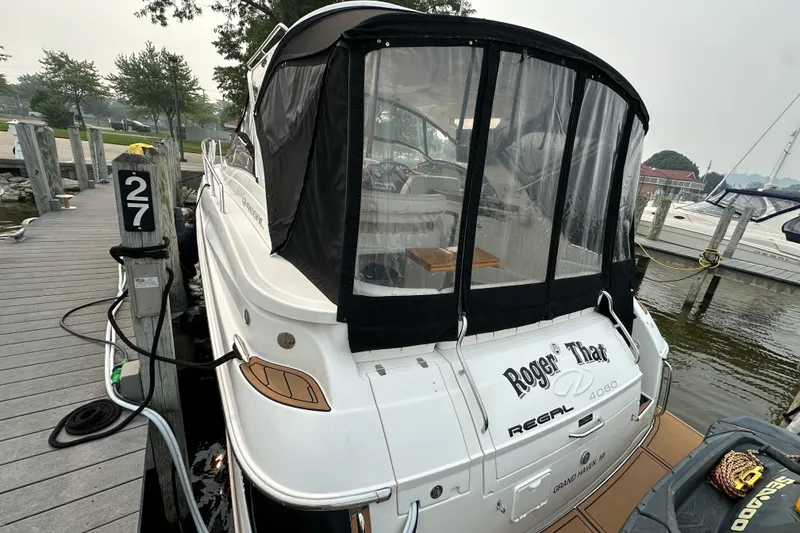 Slide: The Image of 2008 Regal Commodore 4060 yacht docked at marina, featuring "Roger That" name on stern. - 3