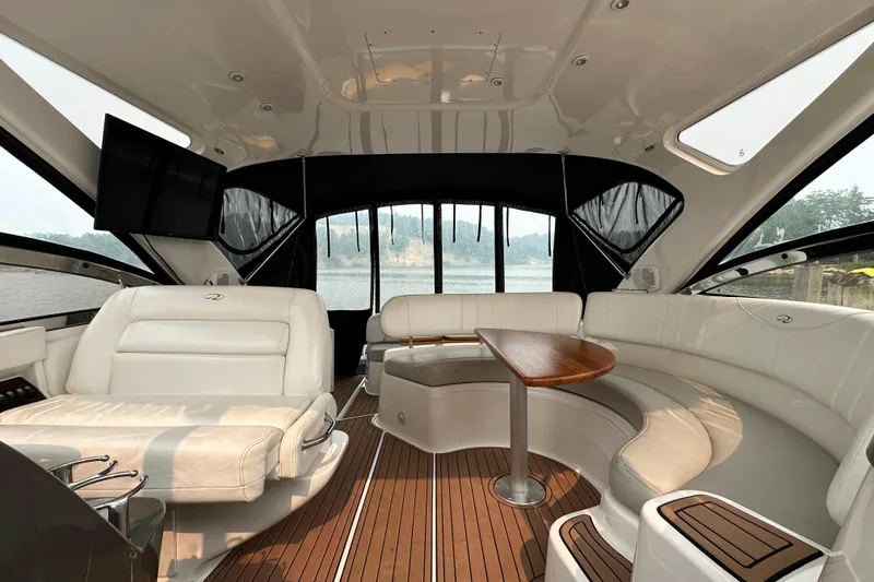 Slide: The Image of Luxurious interior of 2008 Regal Commodore 4060 yacht with elegant seating and wooden table. - 9